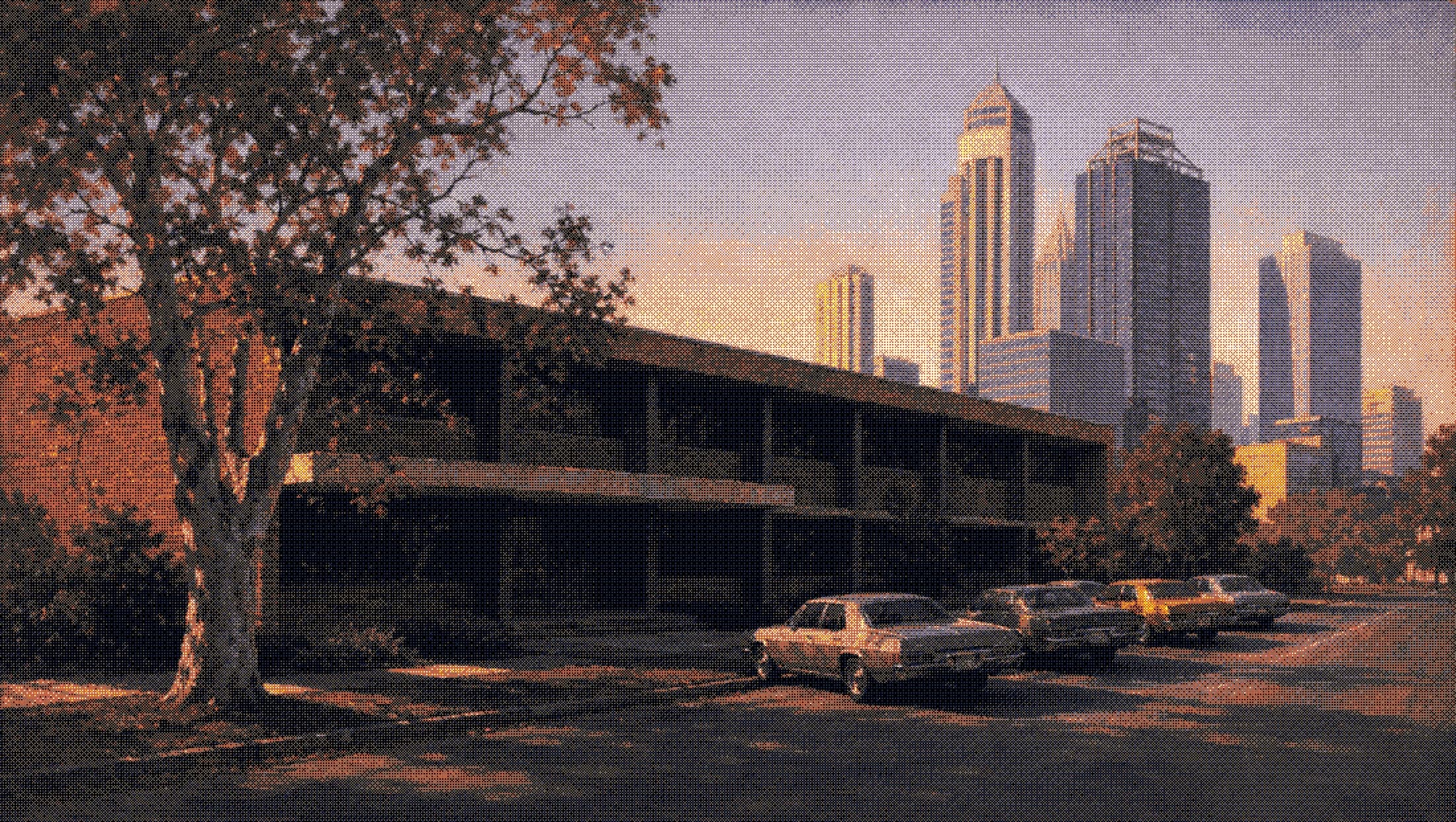 a low west perth office with cars parked out front, the city towers behind